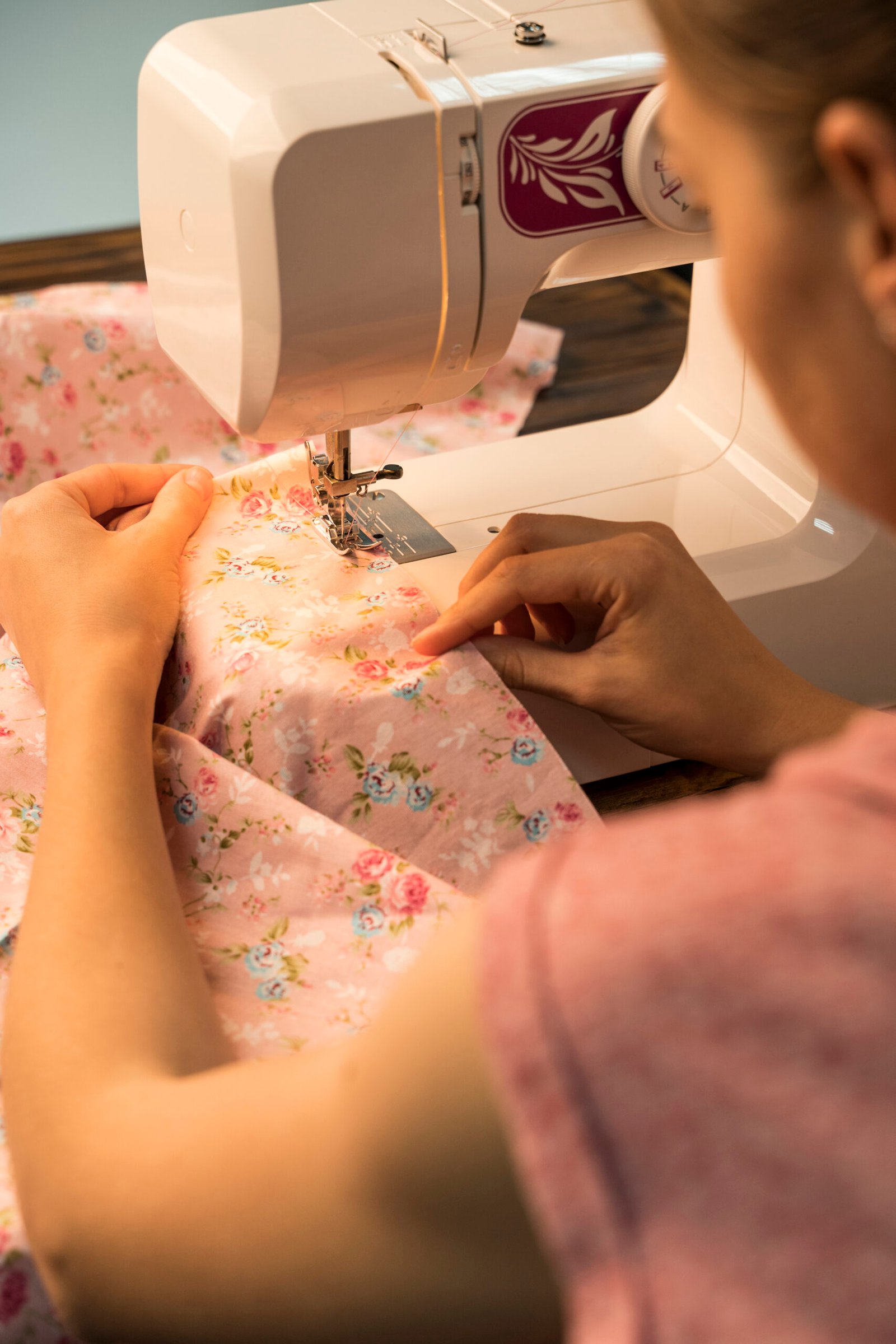 About woman using sewing machine flowery pattern